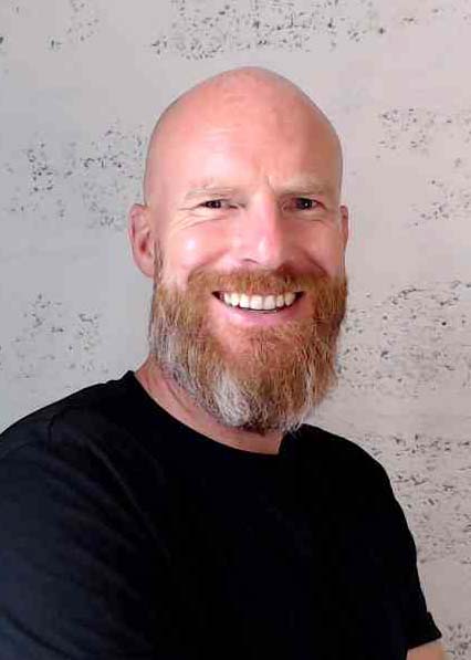 Steve-Gillson-Founder-Mindset-to-Marketing A late forties male with a bald head and long reddish grey beard wearing a black t-shirt